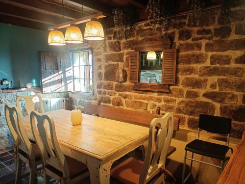 a dining room with a wooden table and chairs at La cabaña mirador de los Valles Pasiegos in Vega de Pas