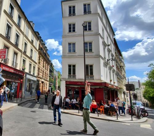 deux hommes jouant à un jeu dans la rue dans l'établissement Une chambre à Paris 20eme avec un petit jardin, à Paris