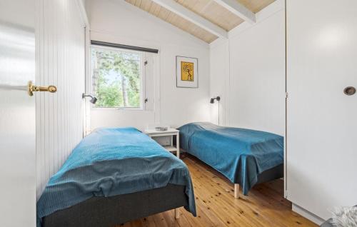 a bedroom with two beds and a window at Lovely Home In Martofte With Sauna in Martofte