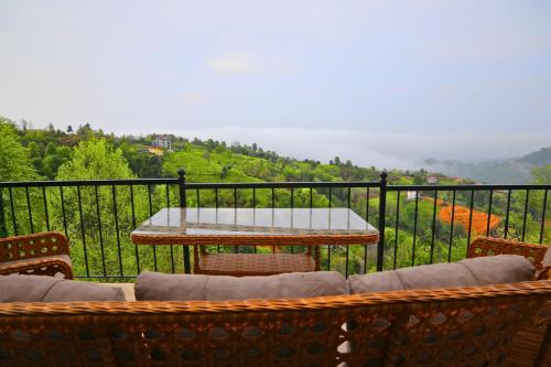 a table and chairs on a balcony with a view at Modul Suit & Bungalov in Rize