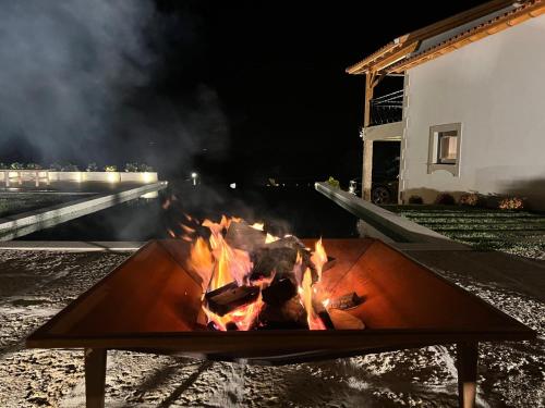 a fire pit in front of a building at night at Quintinha da Mariana - Charming in the Douro Valley in Cinfães