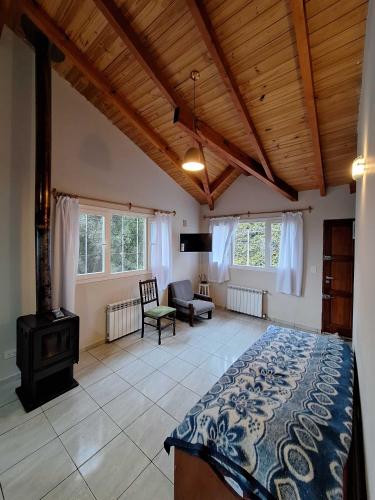 a bedroom with a bed and a stove in a room at Bungalows Luz del sur in San Carlos de Bariloche