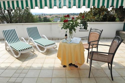 a table and chairs sitting on a patio at Villa Felcaro - Relais, Lodge & Restaurant in Cormòns