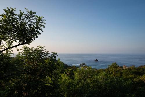 a person riding a wave in the ocean at La Alberca Hotel Boutique in Mazunte