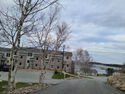 a street in front of a building with trees at Oceanfront Luxury Magical Views Sunset and Sunrise in Western Shore