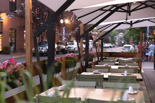 a row of tables and chairs on a street at Oxford Hotel Bend in Bend