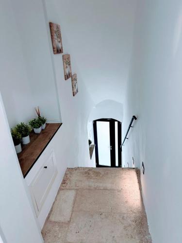 a hallway with a black door in a white room at HOME SWEET HOME Antonella in Valenzano