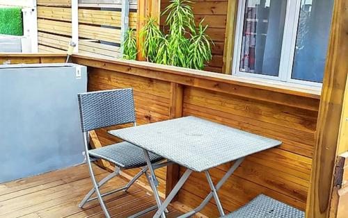 een tafel en twee stoelen op een veranda bij Studio avec jardin et wifi a La Possession in La Possession
