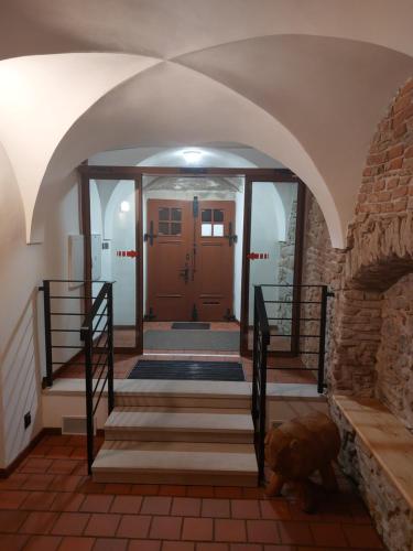 an entrance to a house with a door and stairs at Ubytovanie u Janusa in Levoča