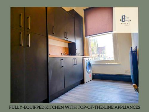 a kitchen with a washer and dryer at Lil Victorian Classic Group Home in Leeds