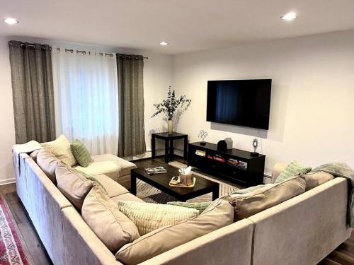 a living room with a couch and a flat screen tv at Spacious Retreat Close to Nature in Bloomingdale