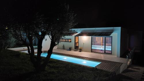 a house with a swimming pool at night at Casa com Alma in Bombarral