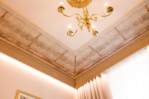 a ceiling in a room with a chandelier at International au Lac Historic Lakeside Hotel in Lugano