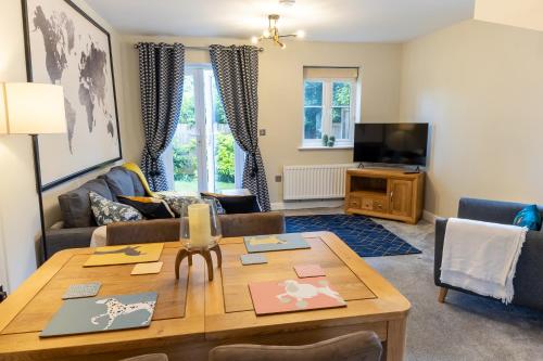 a living room with a table and a couch at Luxury Apartments - MBS Lettings in Bewdley