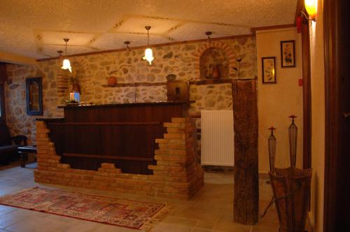 a living room with a brick wall in the middle at Archontiko Mesohori Meteora in Kalabaka