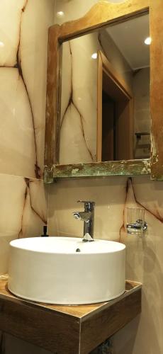 a bathroom with a sink and a mirror at Casa Mameli Αpartments in Kallithea Halkidikis
