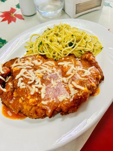 a white plate of food with pasta and meat at Hotel Madrid Chiriqui in David