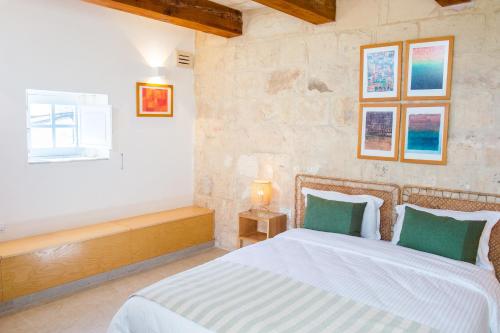 a bedroom with a large bed and a window at San Anton Suites in Attard