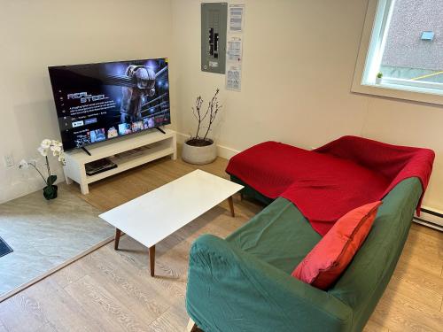 a living room with a couch and a tv at Private room in a Shared house in Vancouver