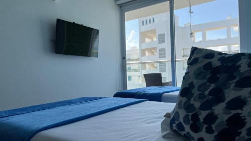 Cama o camas de una habitación en Cerca al Hotel Americas Ctgna Spiaggia Morros Piscina playa
