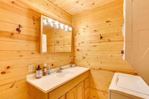 a bathroom with a sink and a mirror at Pets Welcome Cozy Cabin with Deck in Deadwood! in Deadwood