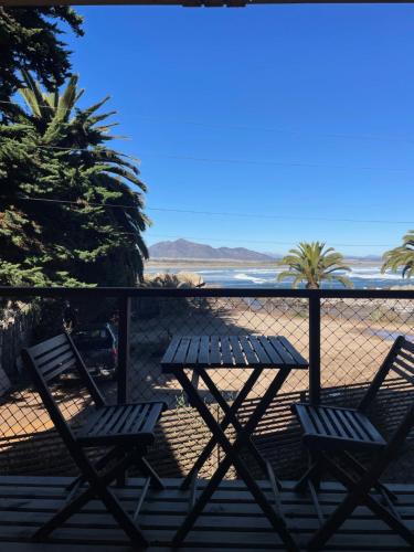 two chairs and a picnic table on the beach at La Ritoqueña Hotel de Playa in Concón