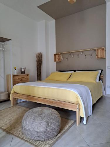 a bedroom with a large bed with a wooden headboard at Macadà in Bari