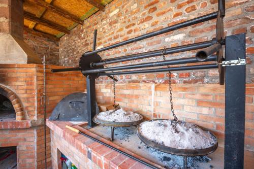 two large pots on top of a brick oven at Hani i Taulant Shahinit in Gramsh