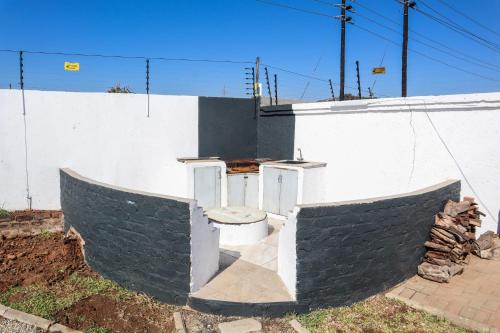 a white building with a toilet in front of it at Bonnie house in Crocodile Valley Estates