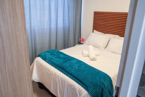 a bedroom with a bed with a blue blanket on it at Bonnie house in Crocodile Valley Estates