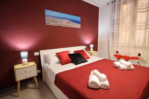 a bedroom with a bed with white shoes on it at A casa di Stefy in Trapani