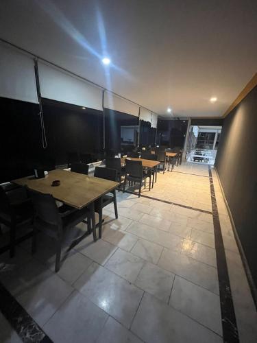 a room with tables and chairs and a light on the wall at Kılıç AirPort otel in Seydiköy