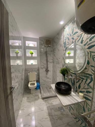 a bathroom with a toilet and a mirror at PORTO MATROUH-GREEN Beach family's only in Marsa Matruh