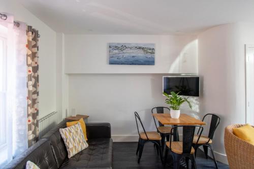a living room with a couch and a table at King's Head Cottage in Hastings