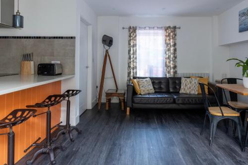 a living room with a couch and a table at King's Head Cottage in Hastings