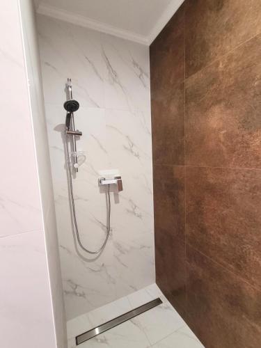 a bathroom with a shower with a sink at Trzy Fale in Dąbrówno
