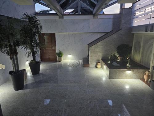 a courtyard with potted plants in a building at Pension Silvia in Portorož