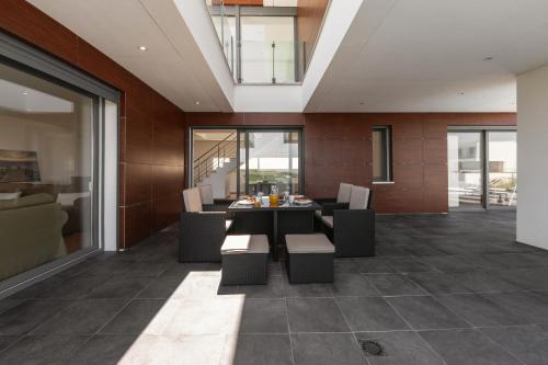 a dining room with a table and chairs at Poolside & Seaview Villa in Lourinhã