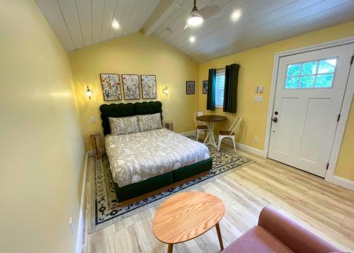 a bedroom with a bed and a table in a room at The Edenwild Boutique Inn in Lopez