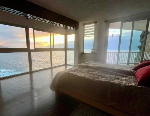 a bedroom with a bed with a view of the ocean at Sea lover's nest in Los Realejos