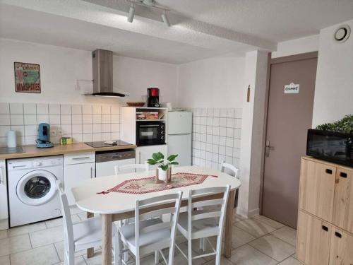 - une cuisine avec une table blanche et des appareils électroménagers blancs dans l'établissement Le ruisseau du Bâmont - Quiet Area, Near Trails, à Saulxures-sur-Moselotte