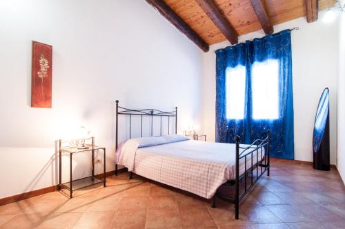 a bedroom with a bed and two side tables at Le Case Al Quadrato Residence in Siracusa
