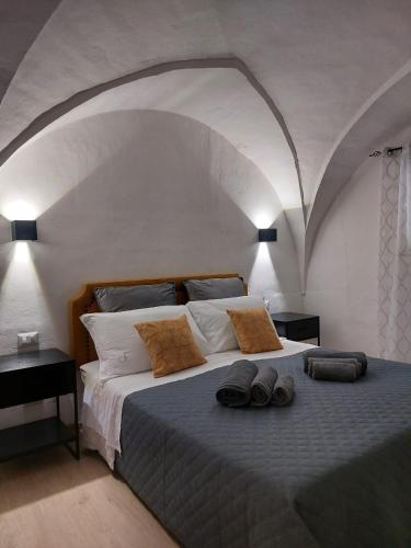a bedroom with a bed with two pairs of shoes on it at Dimora Apulia 5 in Gallipoli