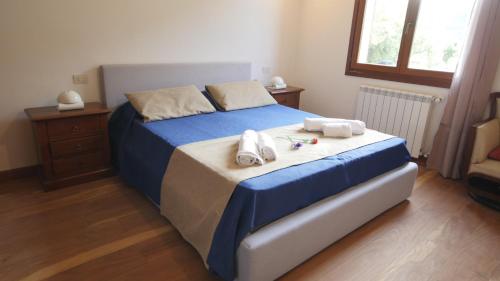 a bedroom with a bed with towels on it at Capalbio - Retreat in Capalbio