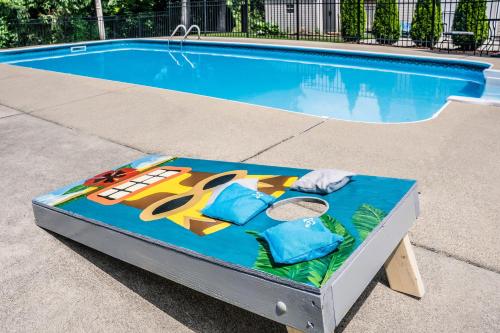 a bed in front of a swimming pool at Cozy Tiffin House with Private Pool 1 Mi to Town! in Tiffin