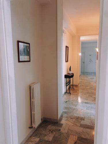 a hallway with a white wall and a radiator at La casa di Michelle in Foggia