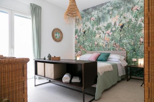 a bedroom with a bed with a large floral wallpaper at Scacciapensieri Sea House in Brucoli