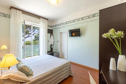 Postel nebo postele na pokoji v ubytování Hotel Adriatica con Piscina