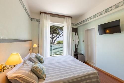 Postel nebo postele na pokoji v ubytování Hotel Adriatica con Piscina