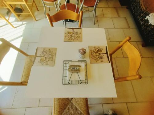 a white table with some drawings on it at La casa sul tetto, Room's & Glamping in Recanati